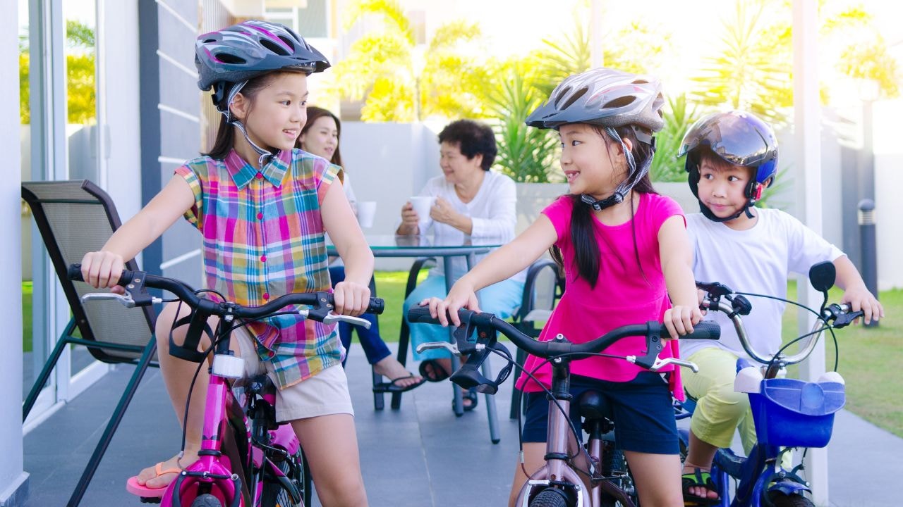 Children riding bikes, enjoying fresh air and outdoor fun during school holidays.