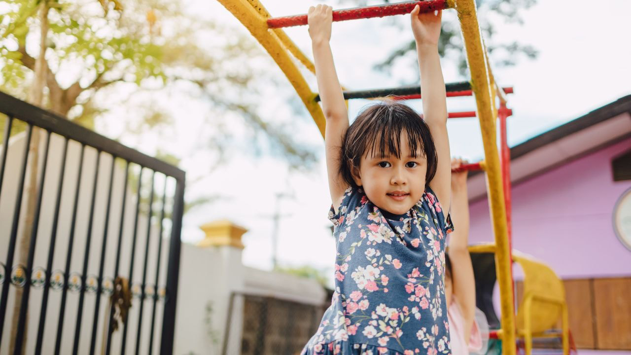 Playing such as climbing in the playground to develop gross motor skills and overall growth